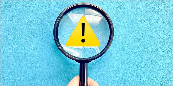 注意マークと虫眼鏡